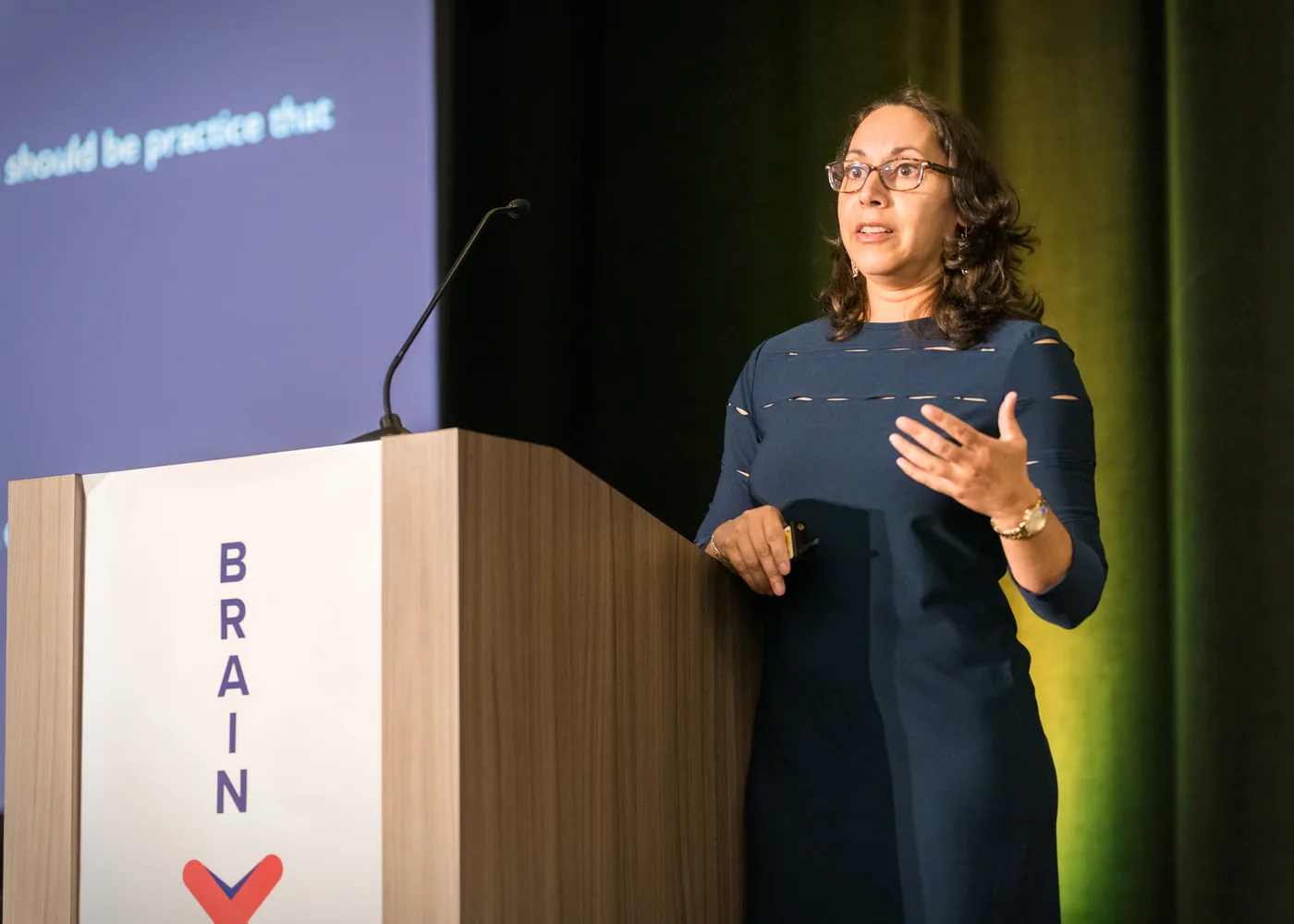 A BrainXchange speaker presenting from the event stage